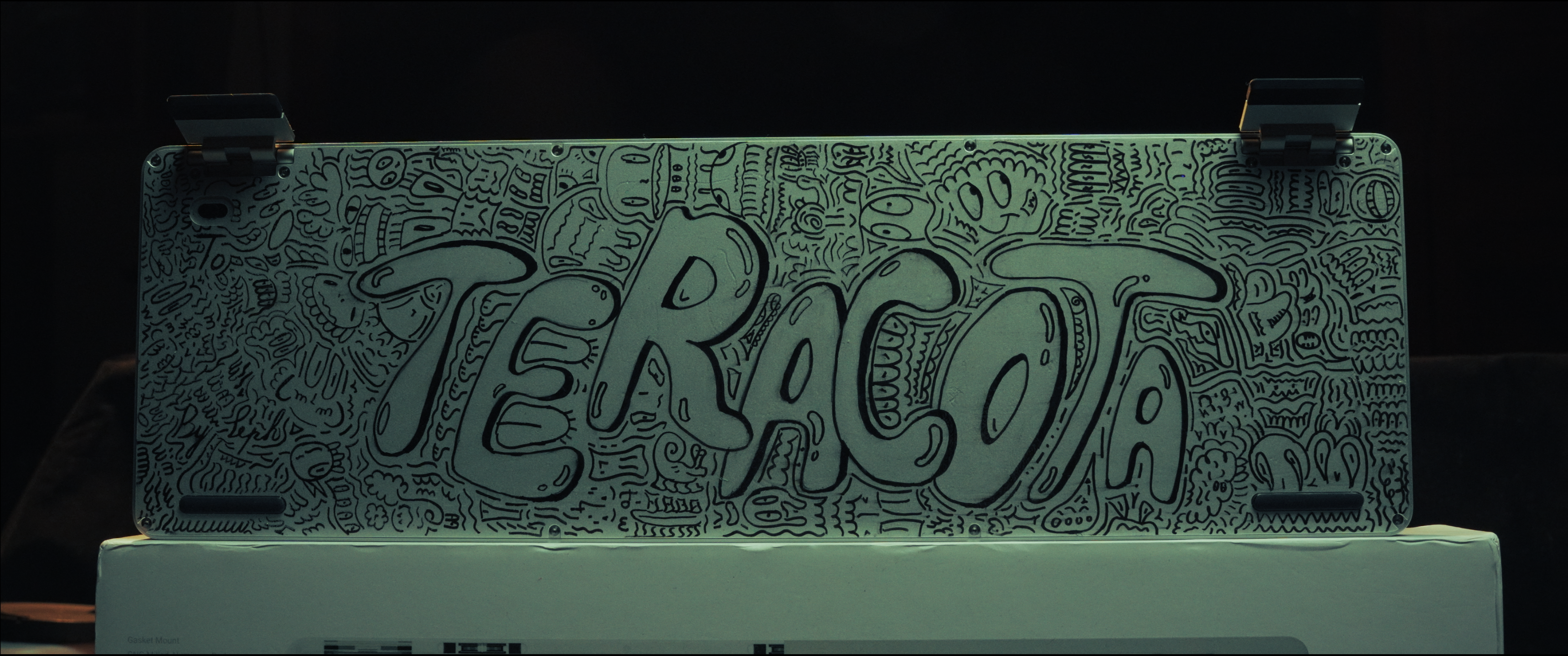 The completed hand-drawn keyboard shell with TERACOTA across the center